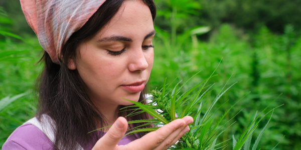 A woman smelling the flavor of Bubba Fett strain